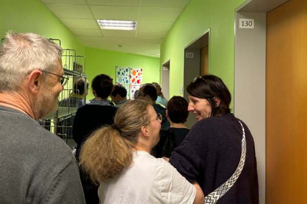 Mehrere Menschen von hinten in einem Flur